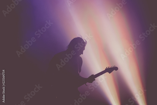 Silhouette of an unrecognizable guitar player