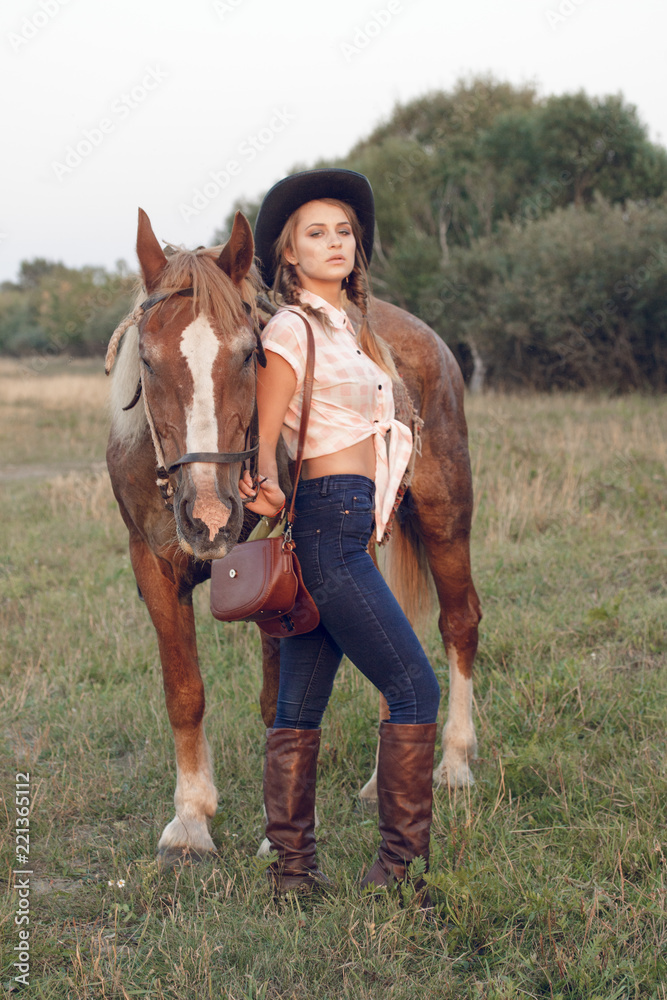 girl in cowboy black hat shirt jeans with horse girl in cowboy black hat shirt jeans with horse