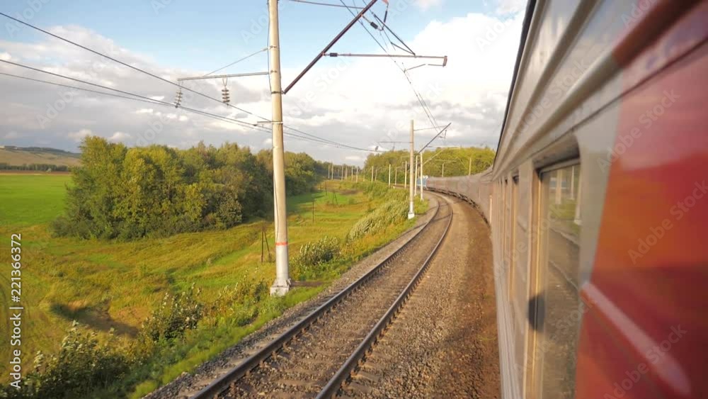 Railroad cars outside train ride on rails near the forest railway. slow motion video. The train lifestyle with the carriages moves next to the forest. concept railroad train cars and train journey