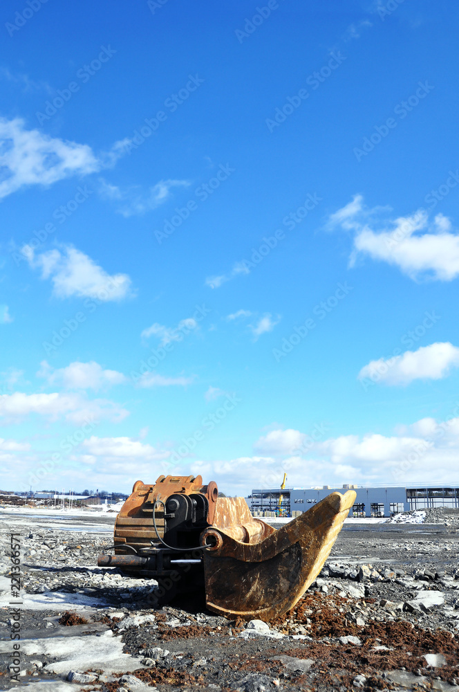 Excavator - Building area in Sweden a sunny day. Load out area with construction in its early stage. Excavator - Building area in Sweden a sunny day. Load out area with construction in its early stage.