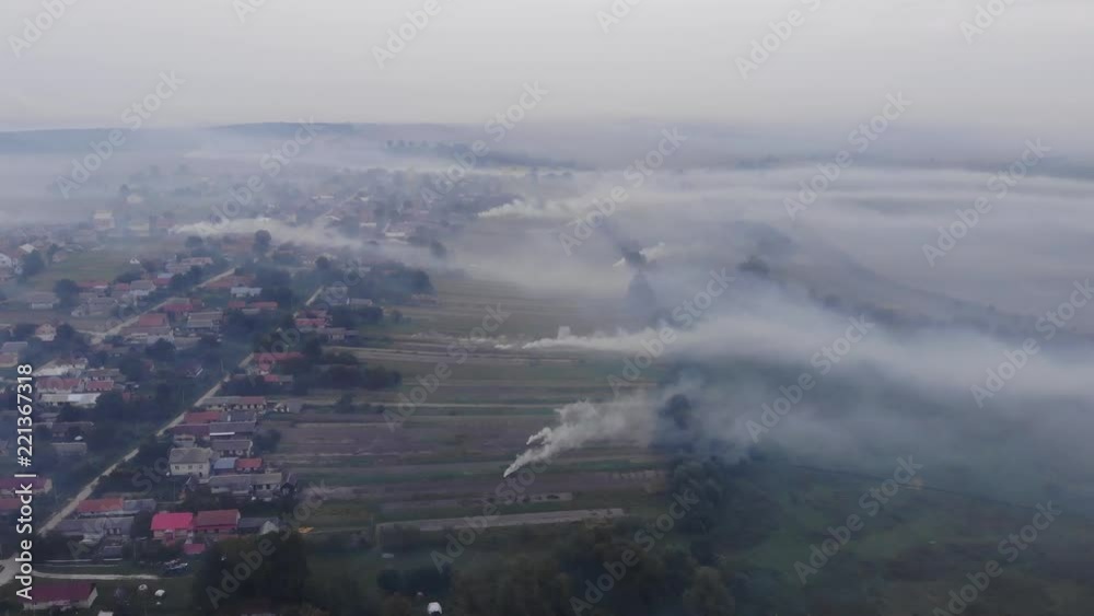 Burning weeds on the field, smoke, damage to environment, atmospheric pollution. Autumn time, rural area, Ukraine Burning weeds on the field, smoke, damage to environment, atmospheric pollution. Autumn time, rural area, Ukraine