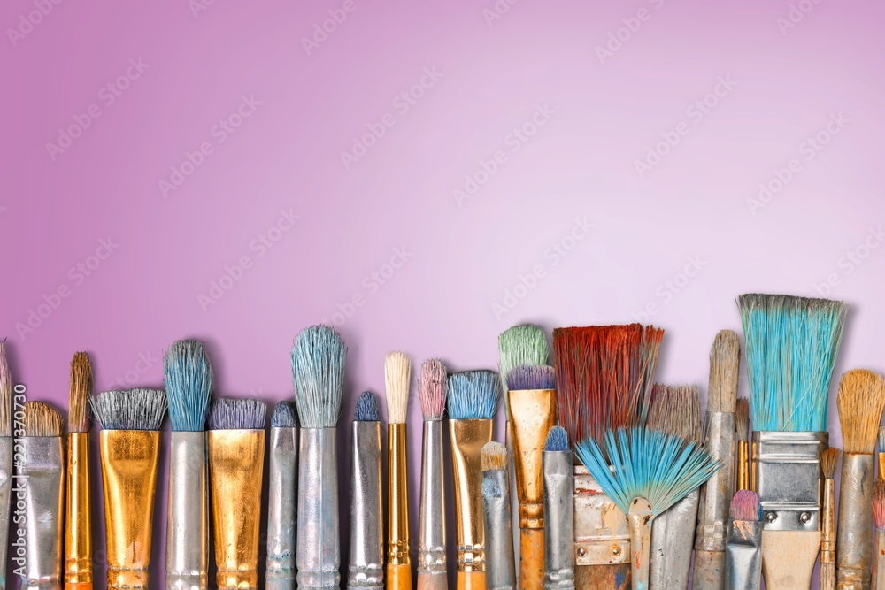 Fototapeta premium Row of artist paint brushes on background