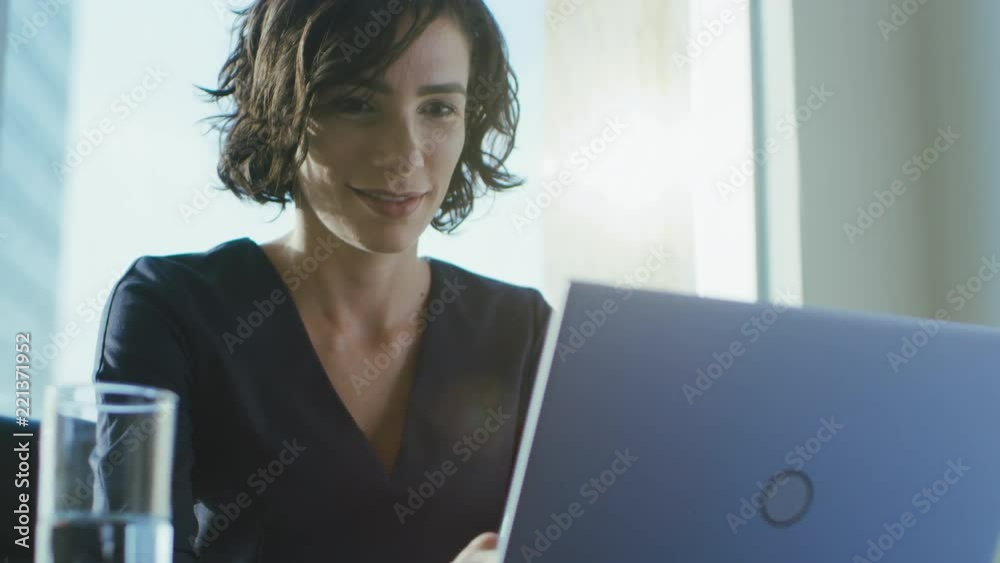 Portrait of the Focused Female CEO Working on a Laptop. Happy Successful Businesswoman Doing Her Important Business Job Beautifully.