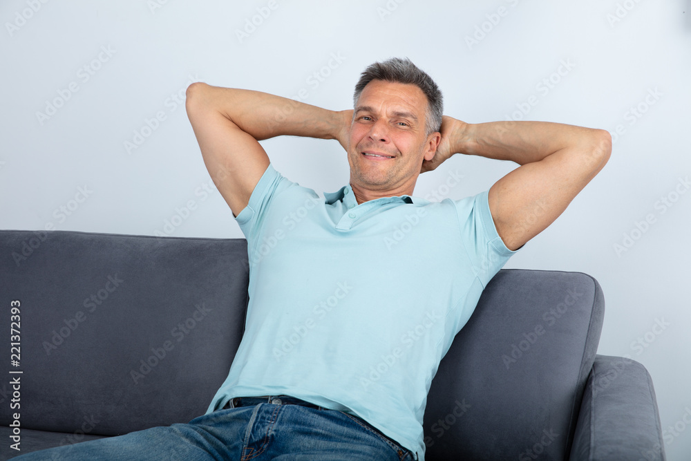 Relaxed Man Sitting On Sofa