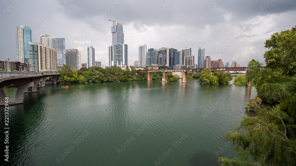 View of Downtown Austin Skyline By Town Lake With Storm Clouds