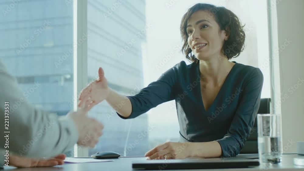 Beatiful Young Businesswoman Talks with a Potential Business Partner and Shakes Hands When them come to a Agrement. Strong Independent Woman in Business Situation. In Slow Motion.