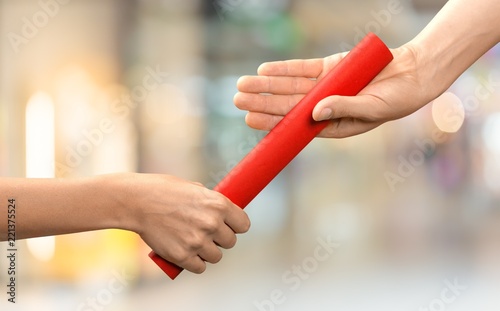 Close-up of relay baton being passed