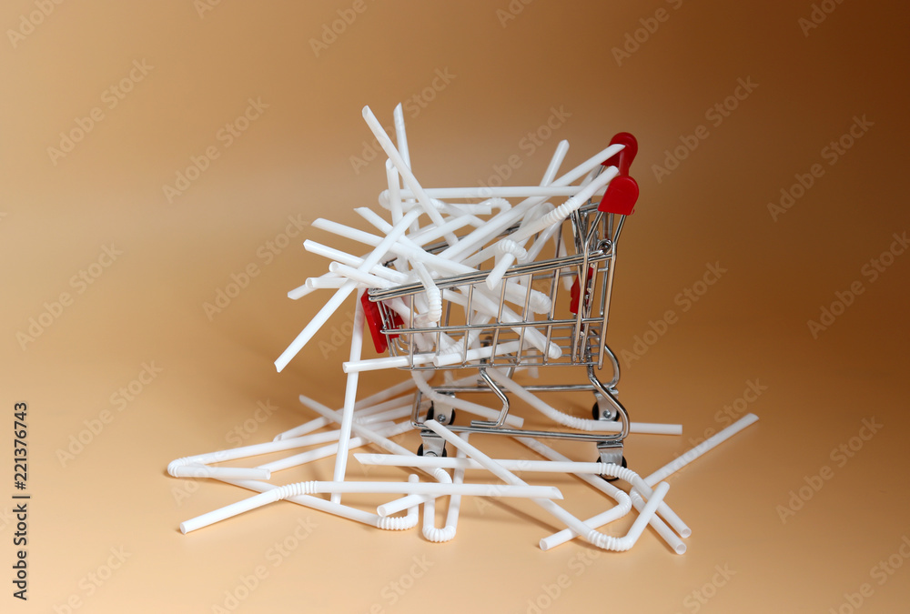 Obraz premium white disposable plastic straws in a shopping cart
