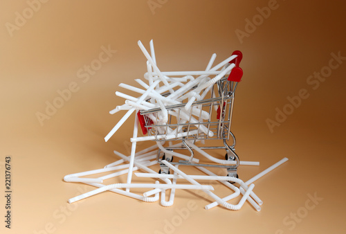 white disposable plastic straws in a shopping cart