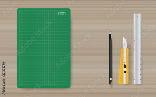 Office object background of green cutting mat with ruler, cutter and pencil on wood. Vector.