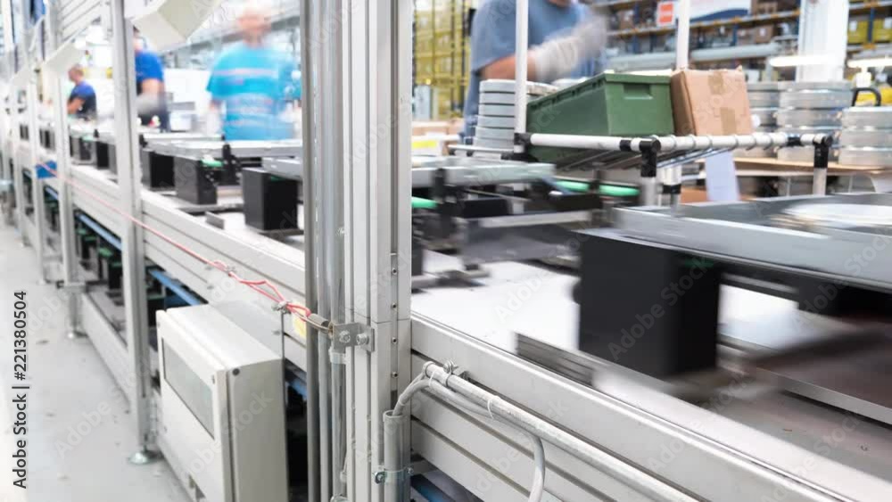 4K Time-lapse group of workers manually assemble parts and components on a industrial assembly line