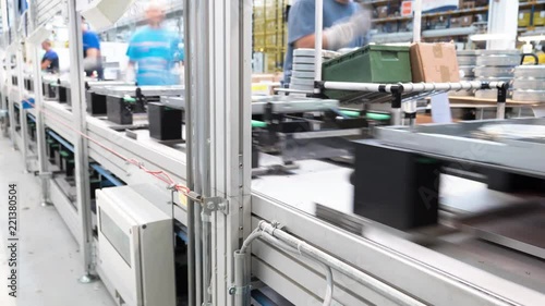 4K Time-lapse group of workers manually assemble parts and components on a industrial assembly line