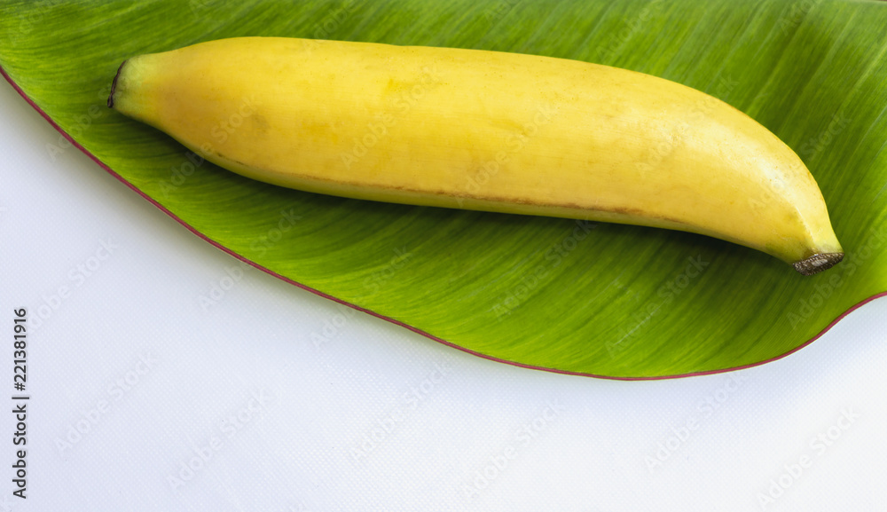 Fresh banana has soft pulpy flesh and yellow skin when ripe with banana leaf isolated on white background.
