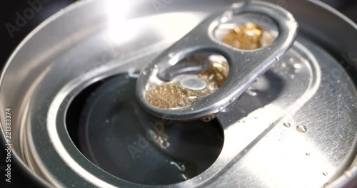 Open the can of soft drinks.