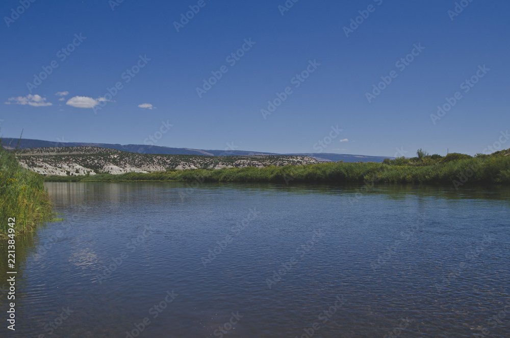 The wide open green river slowly flowing out of utah into colorado in the browns park area. 