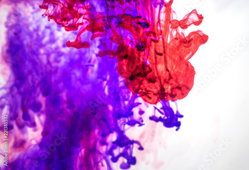 Red and violet ink in the water.
