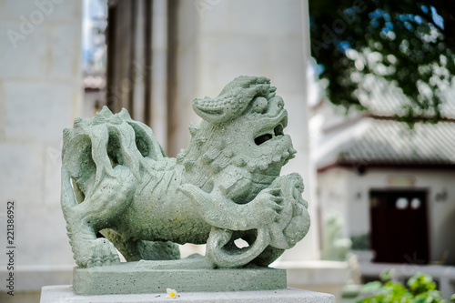 Chinese style Stone lion statue holding a ball in Wat Pho, Bangkok, Thailand
