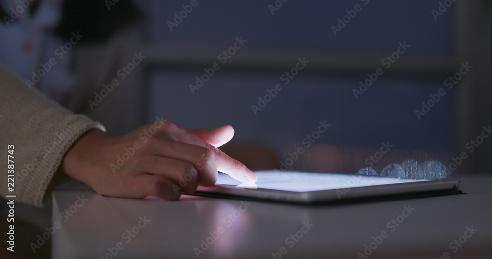 Woman use of tablet computer at night Woman use of tablet computer at night
