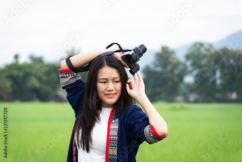 Traveler women taking photo with old fashioned camera. background the nature field rice .Happy tourist woman enjoy and relax serenity vacation. Lifestyle and Travel