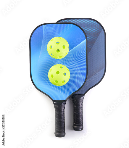 Pickleball paddle and ball on white