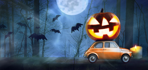 Halloween car delivering pumpkin against night scary autumn forest background