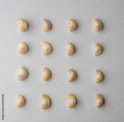 Nuts, cashew placed in pattern on a white wooden table. Tasty and healthy food with lots of vitamins. Top view