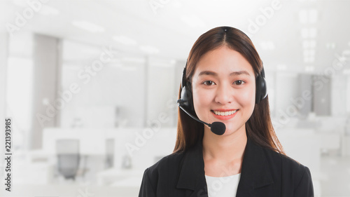 Portrait of Asian beautiful smiling woman customer support phone operator in office space banner background and copy space.Concept call center job service.