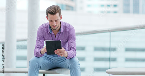 Photography Caucasian man use of tablet computer in the city