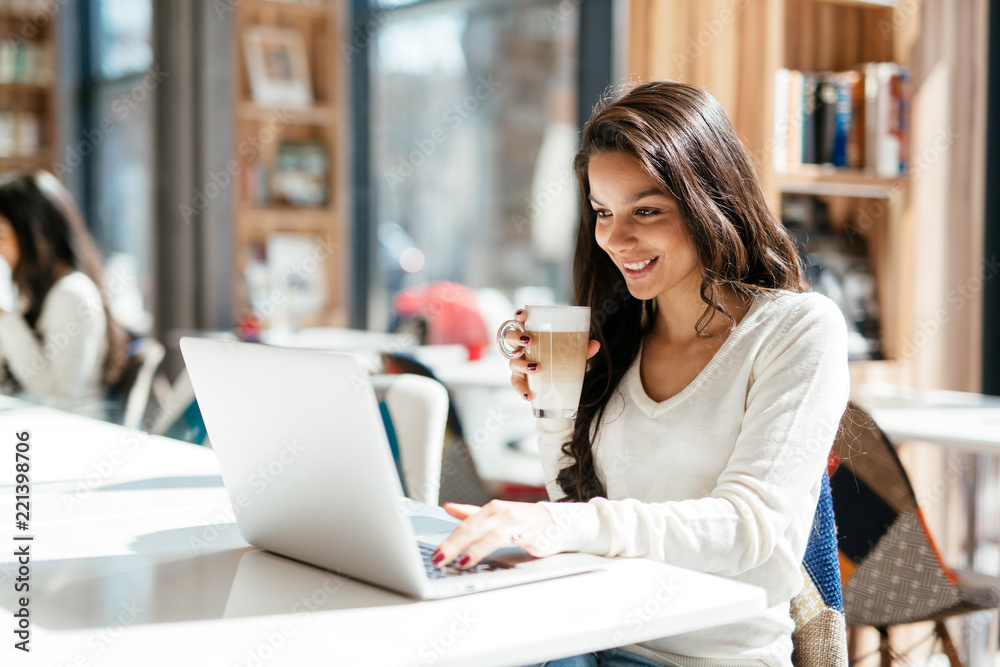 Brunette studying and enjoying coffee Brunette studying and enjoying coffee
