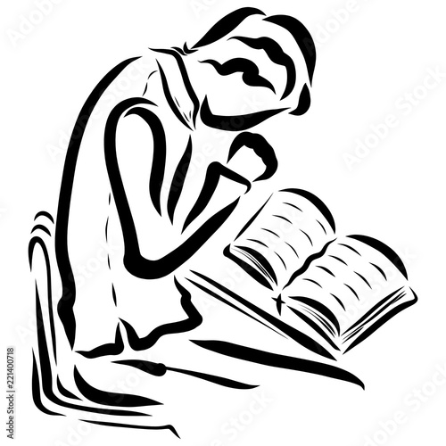 A young man studying the Bible and praying