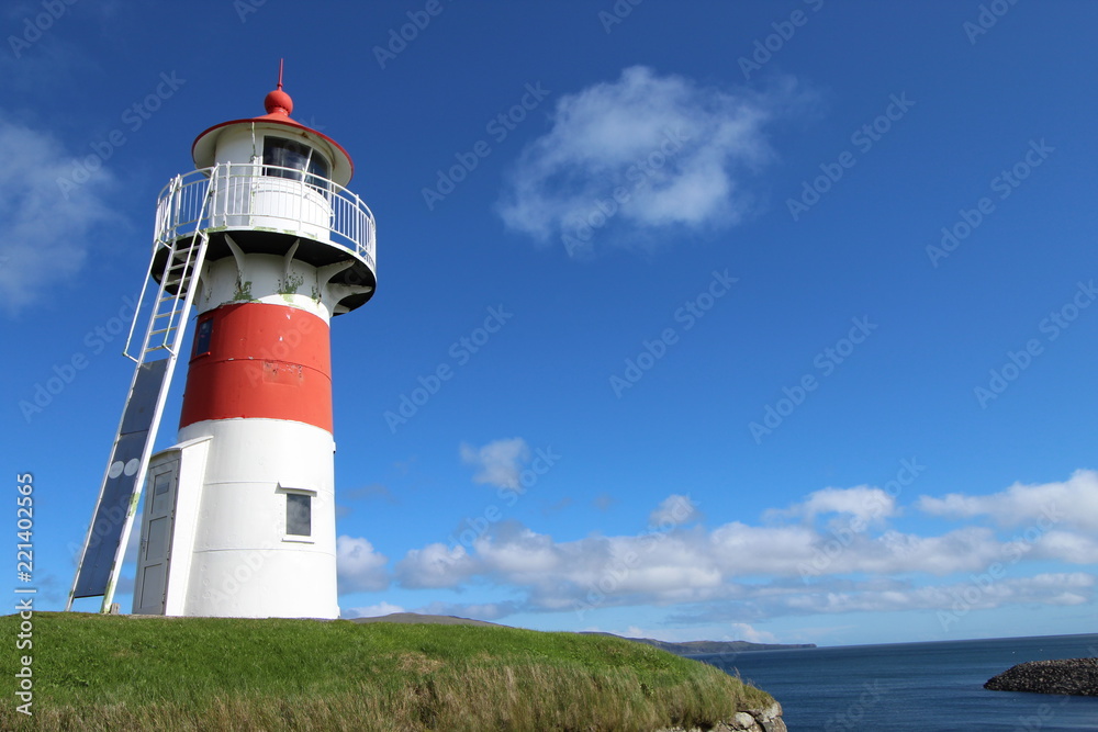 Red and white lighthouse in Torshavn, faroe islands. Sunny summer day