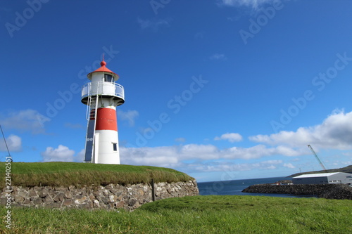 Red and white lighthouse in Torshavn  faroe islands. Sunny summer day