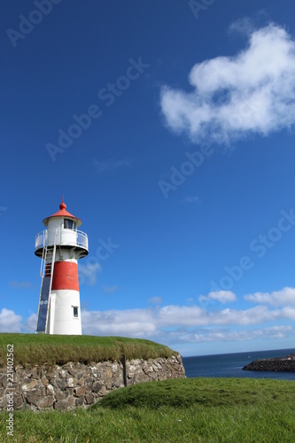 Red and white lighthouse in Torshavn, faroe islands. Sunny summer day