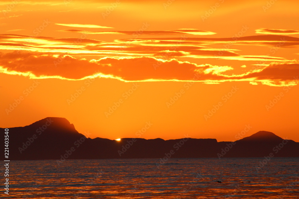 Scenic sunset in Iceland, with orange burning sky. Zoom lens. Scenic sunset in Iceland, with orange burning sky. Zoom lens.