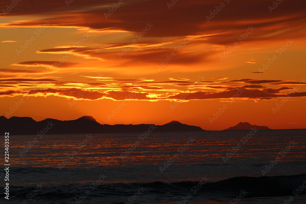 Scenic sunset in Iceland, with orange burning sky. Zoom lens.