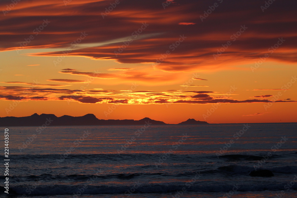 Scenic sunset in Iceland, with orange burning sky. Zoom lens.