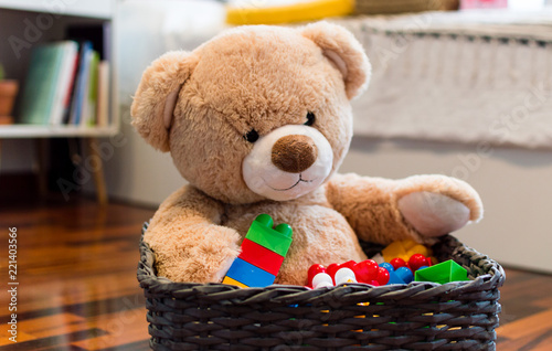 Kids toys background with teddy bear and colorful bricks.