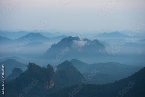 In the morning mountain range with visible silhouettes throug with fog photo