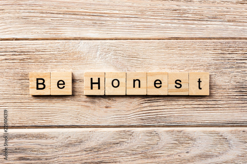 be honest word written on wood block. be honest text on table, concept