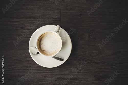 Closeup latte art of coffee white cup on wooden table surface