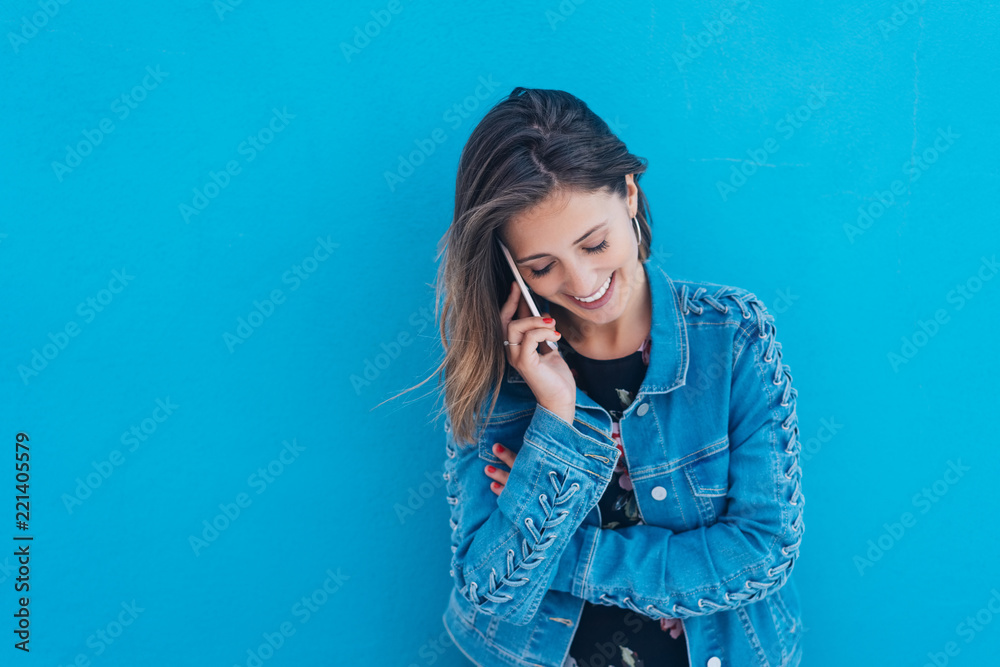 Young woman talking on her mobile outdoors Young woman talking on her mobile outdoors