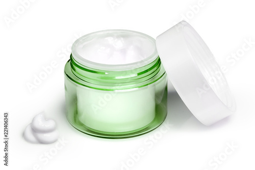 Container of moisturizing face cream on white background. Fashion woman still life. Pop female things, medicine and cosmetic theme.