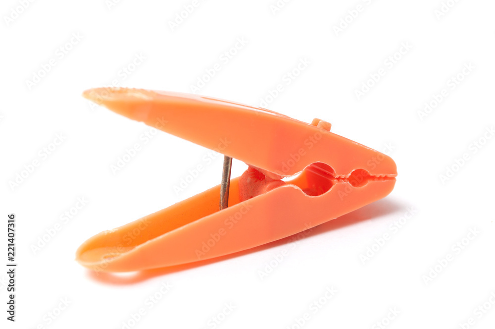 closeup of orange plastic clothespins on white background