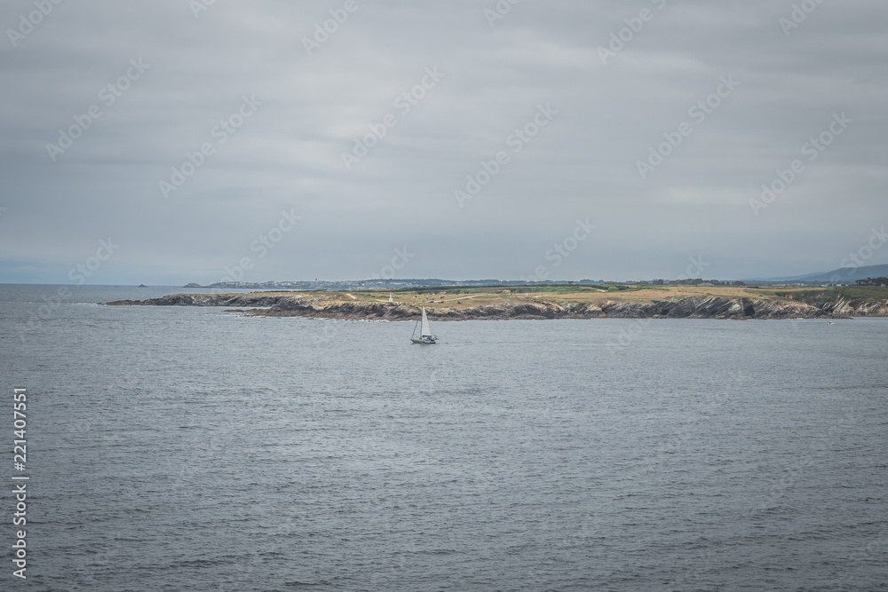 Nice landscape of blue sea with fishing boat and clouds in the sky