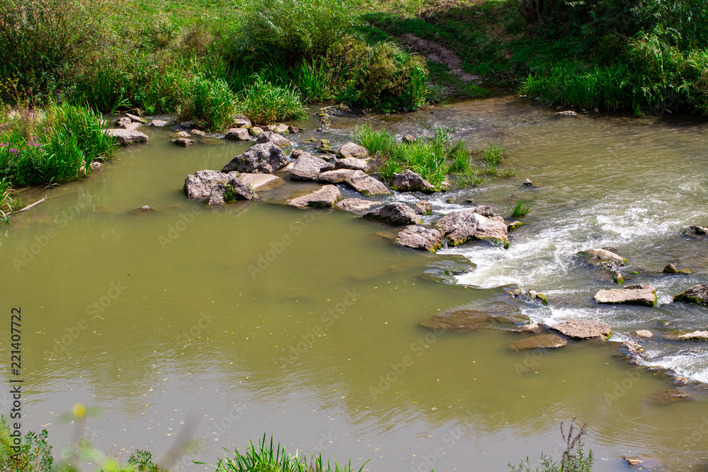 beautiful river with stones in summer on a Sunny day beautiful river with stones in summer on a Sunny day