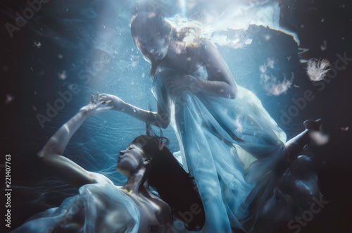 Tablou canvas Beautiful woman swimming with fancy dress underwater