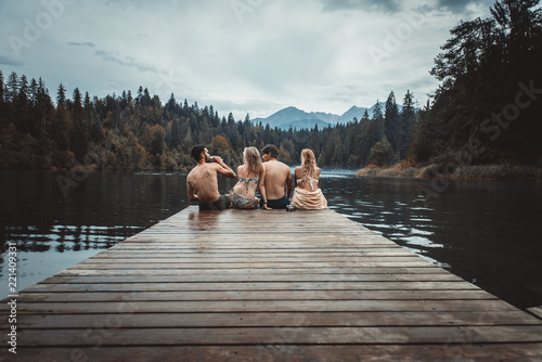 Group of friends having fun at the lake in the morning