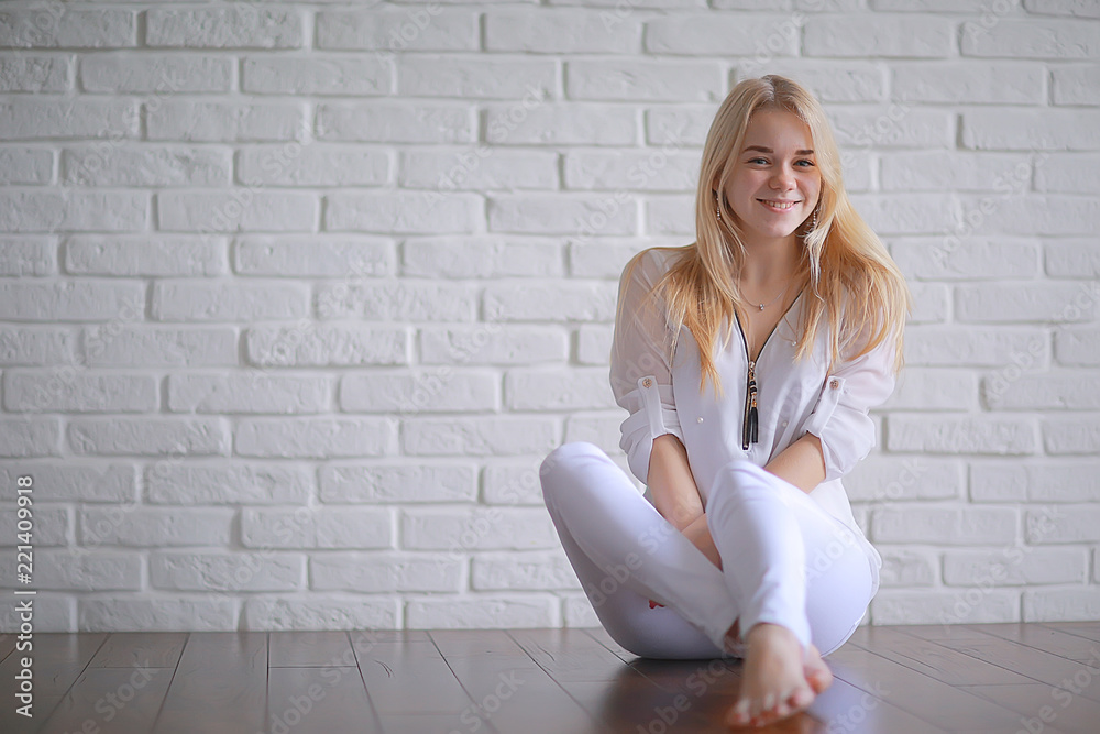 cute blond young adult / portrait of an adult beautiful girl model with blond hair in a happy image