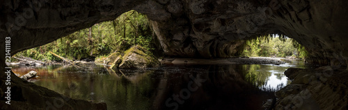 Panoramic view the Oparara River flowing through the 219 metre long Moira Gate Arch. In the Kahurangi National Park, West Coast, New Zealand.
