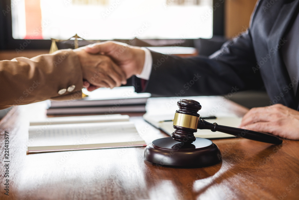 Good service cooperation of Consultation between counselor or male lawyer and business woman customer, Handshake after good deal agreement, Law and Legal concept Good service cooperation of Consultation between counselor or male lawyer and business woman customer, Handshake after good deal agreement, Law and Legal concept